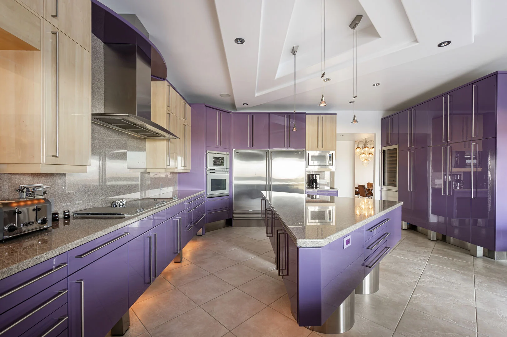 Chef-style kitchen with a long stone island